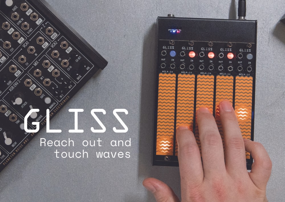 Gliss promotional image A hand on a bank of five Gliss modules, surrounded by other modular objects on a metal table. The text reads